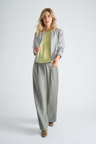 Lime-colored blouse with three-quarter sleeves and elasticated finish