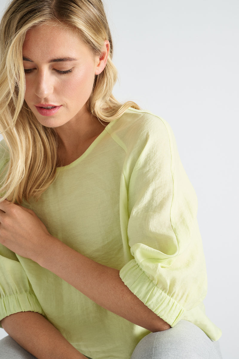 Lime-colored blouse with three-quarter sleeves and elasticated finish