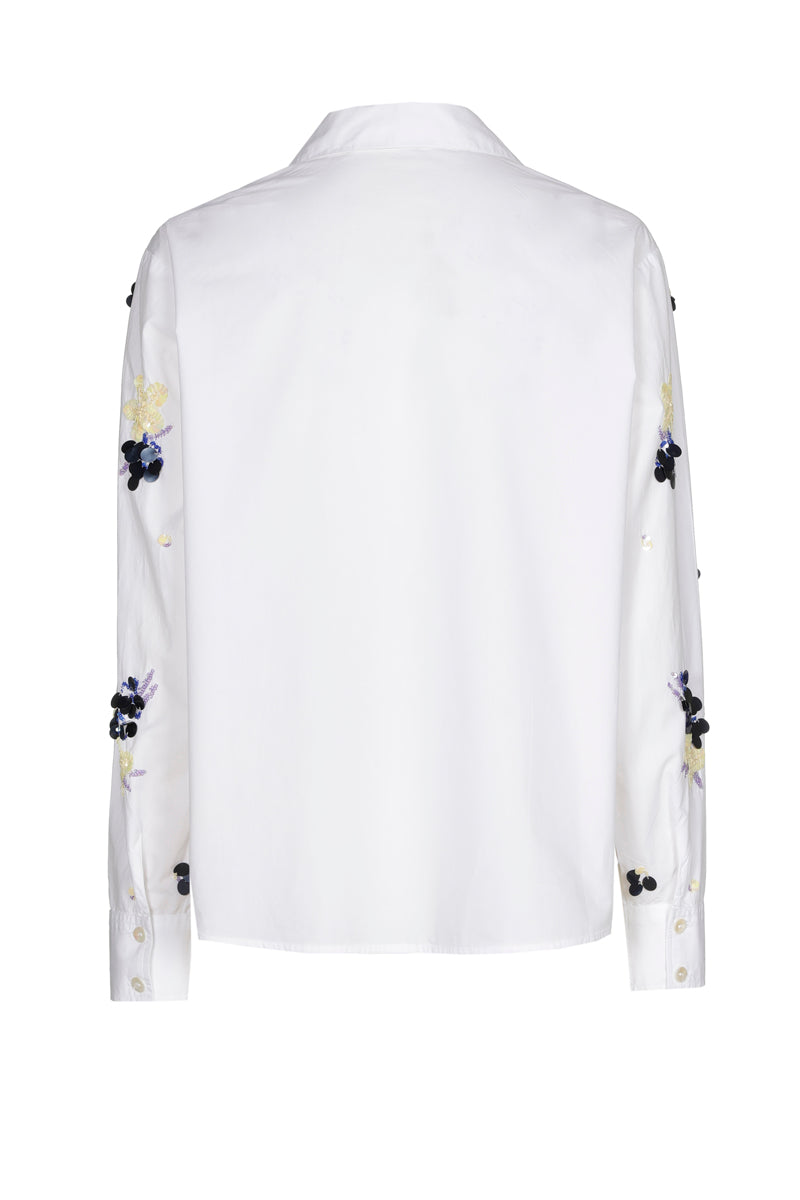 Witte bloes met blauwe pailletten
