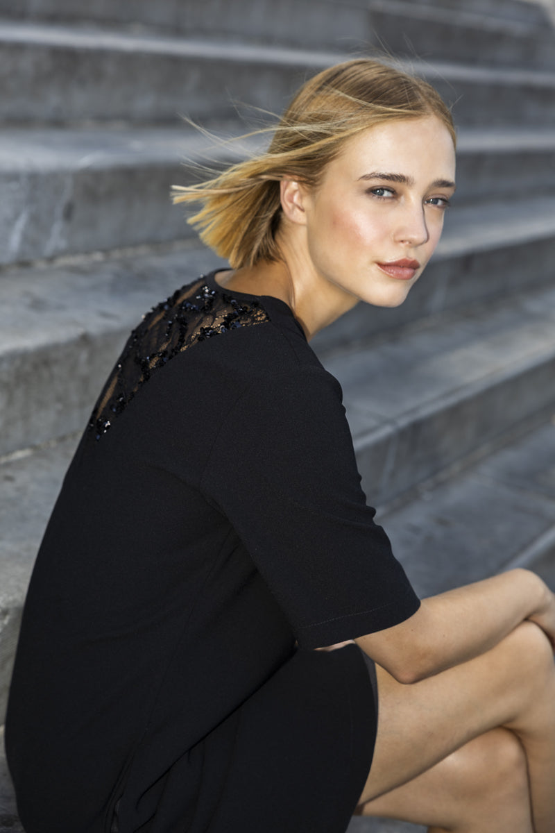 Black knee-length dress with lace back detail